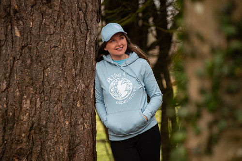 a person standing next to a forest