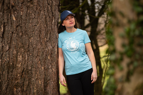 a person standing next to a tree